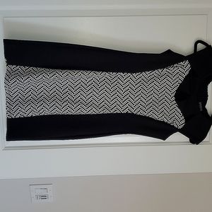 Knee length black dress with white details